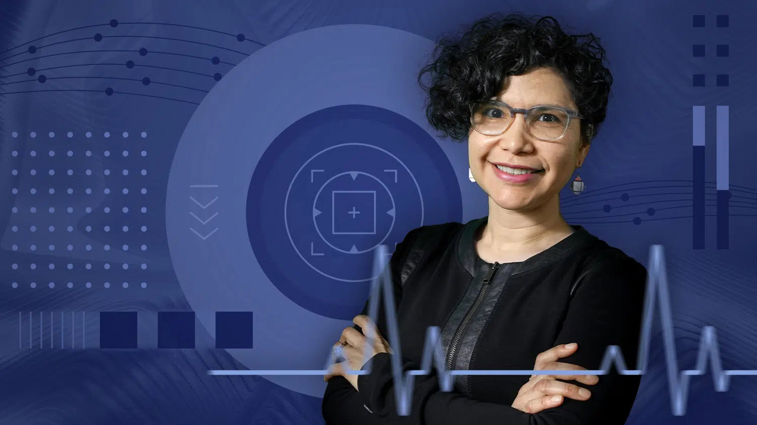Maria Mayorga smiling in front of an abstract blue background.