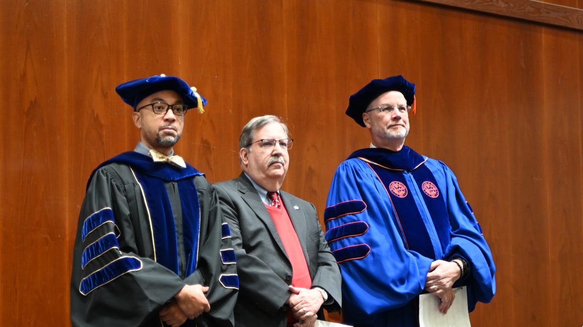 Faculty members Kanton Reynolds, Paul Cohen and Russell King stand as the students enter the room