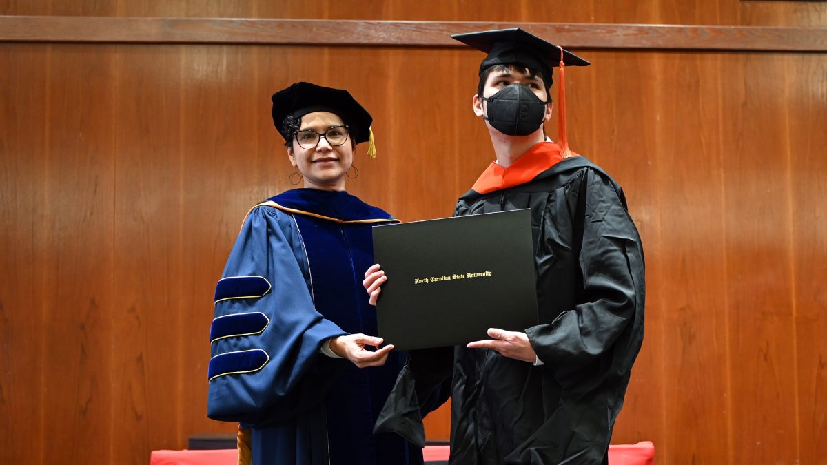 Eric receives his Master of Operations Research from Maria Mayorga