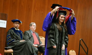 Ph.D. student Jessica Mele gets hooded during the OR Fall 2022 OR Graduation Ceremony