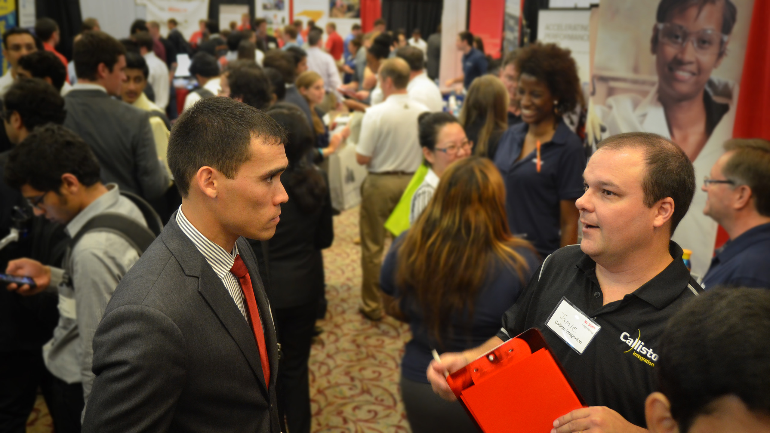 A student talking with a recruiter at the Spring 2023 Engineering Career Fair