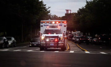 An ambulance at a crowded intersection
