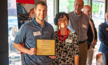 Ph.D. student Cameron Lisy accepting the Salah E. Elmaghraby Distinguished Student Award from OR director Maria Mayorga.
