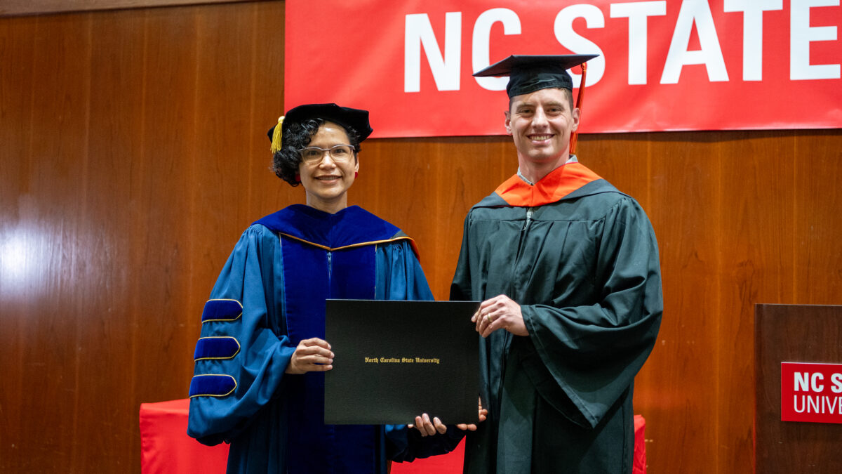 MSOR student Gregory Bremser receives his degree from OR Director Maria Mayorga.