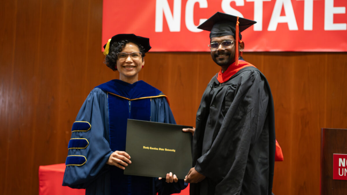 MOR student Harshavardhan Bandaru receives his degree from OR Director Maria Mayorga.