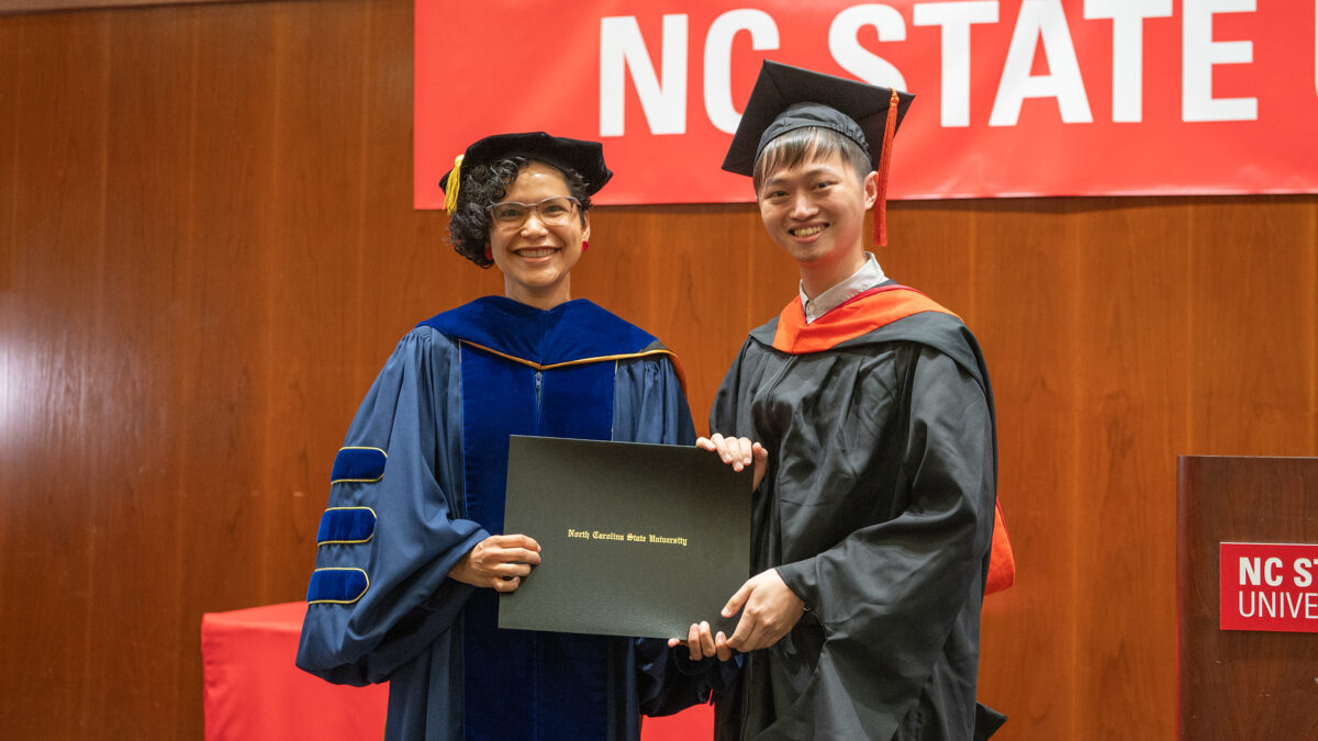 MOR student Hou-An Chen receives his degree from OR Director Maria Mayorga.