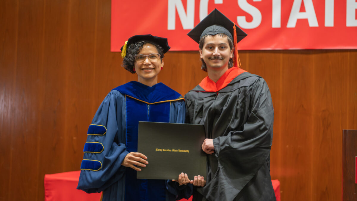 MOR student Paul Matney receives his degree from OR Director Maria Mayorga.